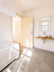 a bathroom with a white tub and a sink at Villa Medica in Kraslice