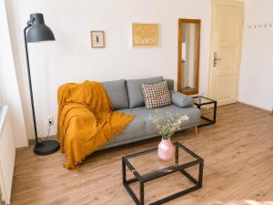 a living room with a couch and a table at Villa Medica in Kraslice