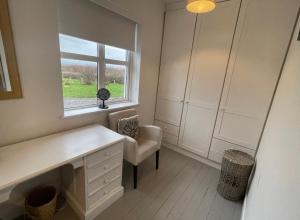 a room with a desk and a chair and a window at Wild Atlantic View in Walshestown