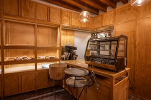a kitchen with a counter with a microwave and a stool at Hotel Casa de las Abuelas in Guanajuato
