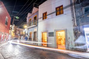 a city street at night with a building at Hotel Casa de las Abuelas in Guanajuato +16 photos