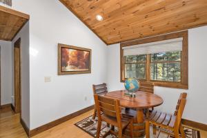 a dining room with a wooden table and chairs at 1 Kingfisher in Blowing Rock