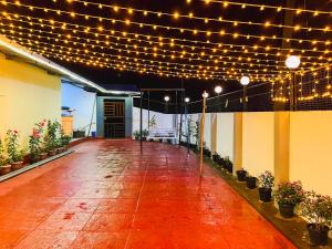 an empty patio with lights and potted plants on it at Munnar Valley View in Munnar