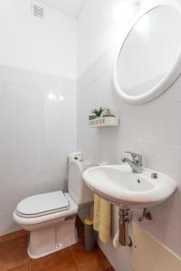 a bathroom with a toilet and a sink and a mirror at Refúgio do Mar -Steps from the Beach- in Armação de Pêra +12 photos