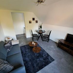 a living room with a couch and a table at Nest and Nature Strauch in Simmerath