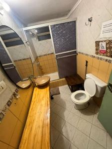 a bathroom with a toilet and a sink in it at Tucan Hostel in Puerto Iguazú +74 photos