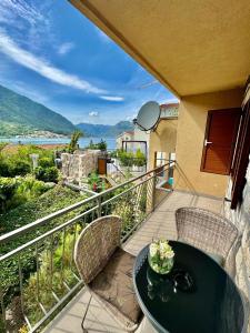 a patio with a table and chairs on a balcony at Apartments Jovanovic - Alkima in Kotor