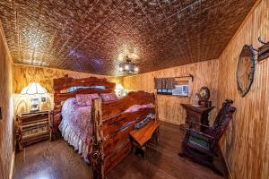 a bedroom with a large bed and a wooden wall at Log Cabin in Helen