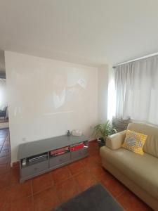 a living room with a couch and a table at Hostal R-Conecta in Cuevas de San Marcos