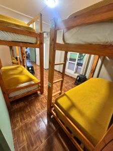 a room with three bunk beds in a room at Tucan Hostel in Puerto Iguazú