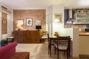 a kitchen and living room with a table and chairs at My Loft 4 You Borgia in Valencia