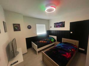 a small room with a bed and a tv at Silver in Quessoy +30 photos