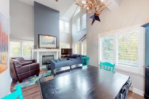 a living room with a table and a couch and a fireplace at Mountain Walk by Property Valet in Blue Mountains
