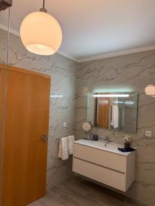 a bathroom with a sink and a mirror at House overlooking the Douro-Casa das Almas in Paços de Gaiolo +48 photos