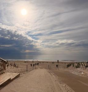 a group of people walking on the beach at Chez Mika in Linxe