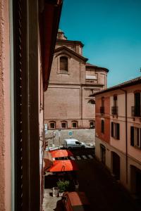 a view from a window of a building with an orange umbrella at Bixio 7 Boutique stay in Imola