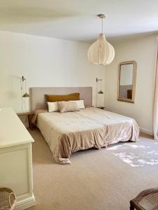 a bedroom with a large bed and a mirror at Luxury family villa with large pool, garden & outdoor dining near beach, Domaine l'Oiseau Bleu in Sainte-Maxime in Sainte-Maxime +38 photos