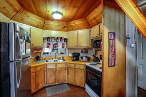 a kitchen with wooden cabinets and a stainless steel refrigerator at Fisherman in Helen