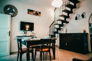 a dining room with a table and a staircase at Bixio 7 Boutique stay in Imola