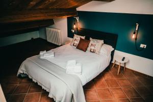 a bedroom with a white bed with a blue wall at Bixio 7 Boutique stay in Imola