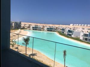 a view of a swimming pool from a balcony at Amazing lagoon view chalet 3 bedrooms in Marsa Matruh