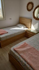 a bedroom with two twin beds and a mirror at Amazing lagoon view chalet 3 bedrooms in Marsa Matruh
