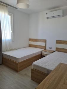 a bedroom with two beds and a window at Amazing lagoon view chalet 3 bedrooms in Marsa Matruh