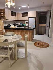 a kitchen with a table and chairs and a counter at Amazing lagoon view chalet 3 bedrooms in Marsa Matruh