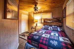 a bedroom with a bed in a wooden room at Fisherman in Helen