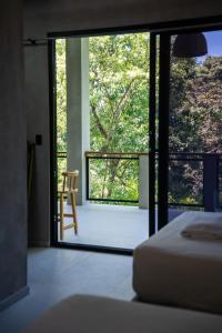 a bedroom with a glass door leading to a balcony at Shalpabay house - Private Apartments and Rooms in Taquillo +73 photos
