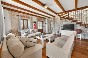 a living room with two couches and a tv at Villa Stone-Exceptional private Estate in Mlini