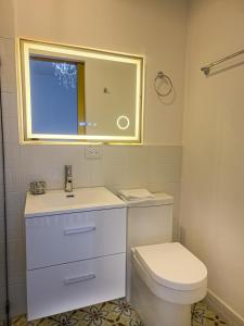 a bathroom with a toilet and a sink and a window at Hotel Casa Dharma in Popayan +24 photos