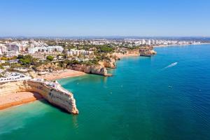 an aerial view of a beach with buildings and the ocean at Refúgio do Mar -Steps from the Beach- in Armação de Pêra