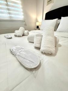 a white bed with towels on top of it at Archanes Cozy Retreat in Archanes