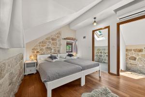 a bedroom with a bed and a stone wall at Villa Stone-Exceptional private Estate in Mlini +41 photos