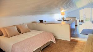 a bedroom with a bed and a kitchen with a table at JC Seaside in Vila Franca do Campo
