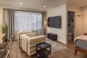 a living room with a couch and a chair at Modern Studio Downtown Anchorage in Anchorage +10 photos