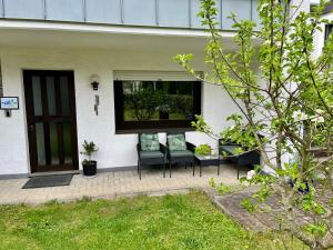 a porch with two chairs and a window at Gate 18 in Haiger