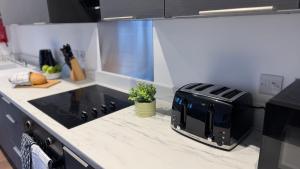 a kitchen with a toaster sitting on a counter at Central Old Town 1-Bed Apartment in Swindon