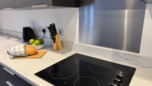 a kitchen counter with a black stove top oven at Central Old Town 1-Bed Apartment in Swindon