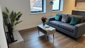 a living room with a couch and a coffee table at Central Old Town 1-Bed Apartment in Swindon +4 photos
