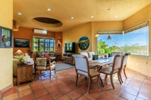 a dining room and living room with a table and chairs at Casa Silverado in Buenavista