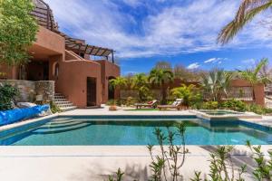 a swimming pool in front of a house at Casa Silverado in Buenavista