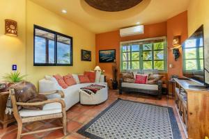a living room with a white couch and a tv at Casa Silverado in Buenavista