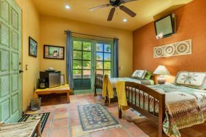 a bedroom with a bed and a tv and a window at Casa Silverado in Buenavista +15 photos