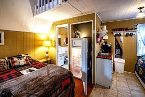a small room with a refrigerator and a kitchen at Hilltop Loft in Helen
