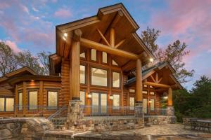 a log home with a wrap around porch at Hamatreya- Panoramic Shenandoah Views in Rileyville