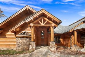 a log home with a front door and a gambrel roof at Hamatreya- Panoramic Shenandoah Views in Rileyville
