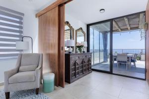 a living room with a chair and a table at Modern 4BR Villa with Rooftop & Pickleball in Los Barriles