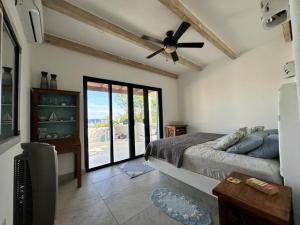 a bedroom with a bed and a ceiling fan at Ocean Views Pool 2 Bedroom in Los Barriles